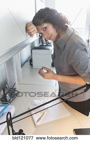 Stock Photo - Hispanic businesswoman working in office. Fotosearch