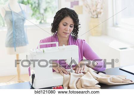 Hispanic dressmaker working at sewing machine View Large Photo Image Stock Image - Hispanic dressmaker working at sewing machine. Fotosearch