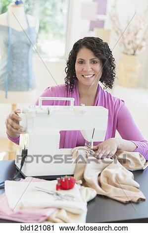 Hispanic dressmaker working at sewing machine View Large Photo Image Stock Image - Hispanic dressmaker working at sewing machine. Fotosearch