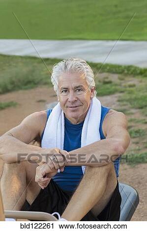 Stock Image - Hispanic man exercising in park. Fotosearch