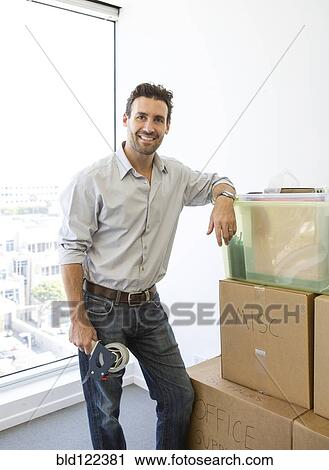 Hispanic man packing cardboard boxes View Large Photo Image Stock Image - Hispanic man packing cardboard boxes. Fotosearch