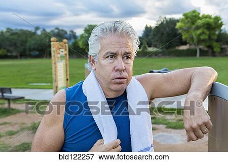 Stock Photo - Hispanic man resting in park. Fotosearch