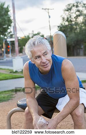 Hispanic man resting in park View Large Photo Image Stock Photo - Hispanic man resting in park. Fotosearch