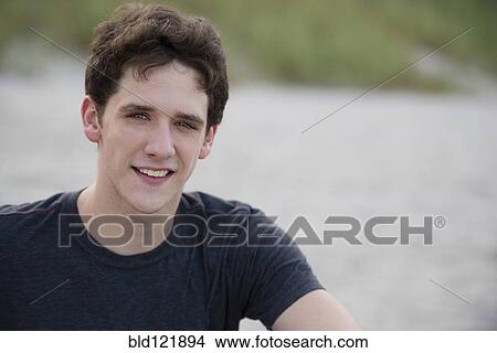 Hispanic man smiling on beach View Large Photo Image Picture - Hispanic man smiling on beach. Fotosearch