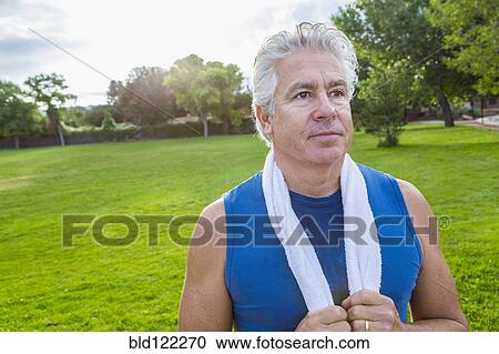 Stock Image - Hispanic man standing in park. Fotosearch