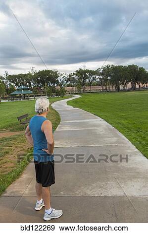 Hispanic man standing in park View Large Photo Image Stock Photo - Hispanic man standing in park. Fotosearch