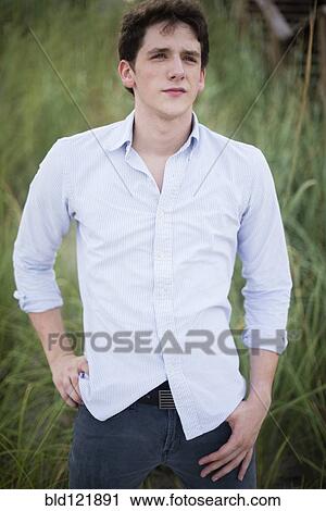 Hispanic man standing in tall grass View Large Photo Image Stock Image - Hispanic man standing in tall grass. Fotosearch