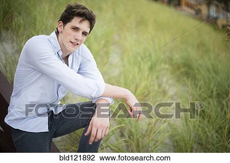 Hispanic man standing in tall grass View Large Photo Image Stock Image - Hispanic man standing in tall grass. Fotosearch
