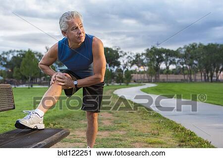 Hispanic man stretching in park View Large Photo Image Stock Image - Hispanic man stretching in park. Fotosearch
