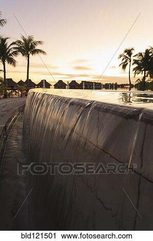 Stock Image - Infinity pool at tropical resort. Fotosearch