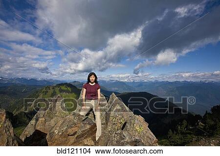 Picture - Japanese woman posing on mountain top. Fotosearch