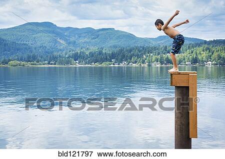 Korean boy jumping off platform into lake View Large Photo Image Stock Photo - Korean boy jumping off platform into lake. Fotosearch