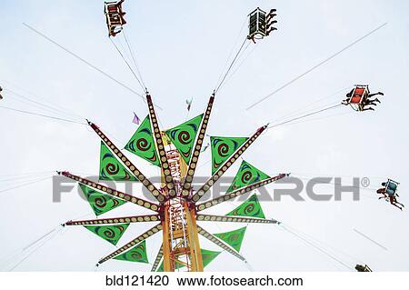 Low angle view of fairground ride View Large Photo Image Stock Image - Low angle view of fairground ride. Fotosearch