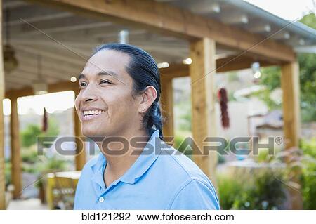 Stock Image - Man smiling outdoors. Fotosearch