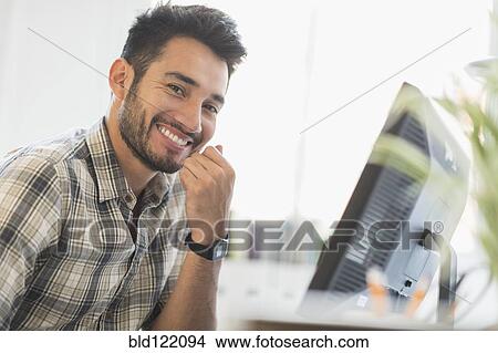 Picture - Mixed race businessman smiling in office. Fotosearch