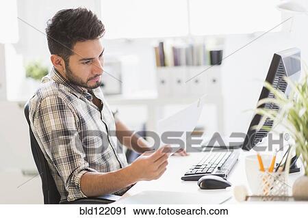 Mixed race businessman working in office View Large Photo Image Stock Image - Mixed race businessman working in office. Fotosearch