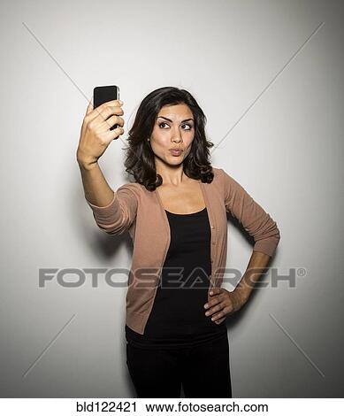 Mixed race businesswoman taking cell phone picture View Large Photo Image Stock Image - Mixed race businesswoman taking cell phone picture. Fotosearch