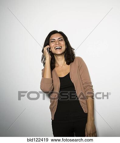 Stock Photo - Mixed race businesswoman talking on cell phone. Fotosearch
