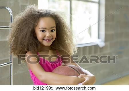Mixed race girl holding basketball View Large Photo Image Stock Photography - Mixed race girl holding basketball. Fotosearch