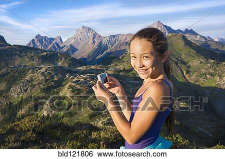 Mixed race girl photographing mountains, North Cascade Mountains, Washington, United States View Large Photo Image Stock Photograph - Mixed race girl photographing mountains, North Cascade Mountains, Washington, United States. Fotosearch