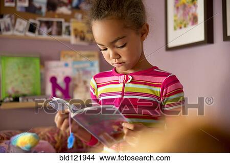 Mixed race girl reading in bedroom View Large Photo Image Picture - Mixed race girl reading in bedroom. Fotosearch