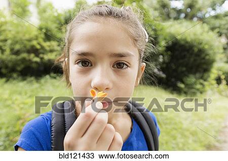 Mixed race girl smelling flower View Large Photo Image Stock Image - Mixed race girl smelling flower. Fotosearch