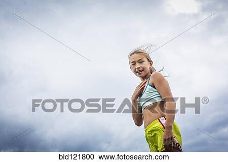 Stock Image - Mixed race girl smiling. Fotosearch