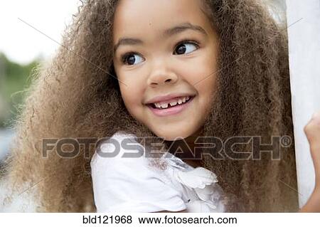 Stock Photo - Mixed race girl smiling. Fotosearch