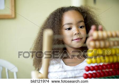 Mixed race girl using abacus View Large Photo Image Picture - Mixed race girl using abacus. Fotosearch