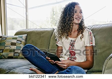 Mixed race girl using digital tablet View Large Photo Image Stock Image - Mixed race girl using digital tablet. Fotosearch