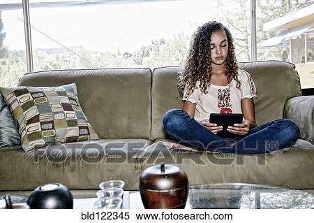 Stock Photography - Mixed race girl using digital tablet. Fotosearch