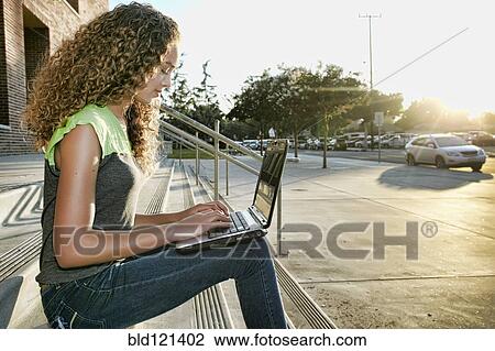 Mixed race girl using laptop on steps View Large Photo Image Stock Image - Mixed race girl using laptop on steps. Fotosearch