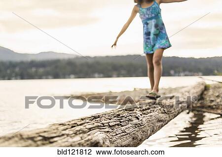 Mixed race girl walking on log View Large Photo Image Stock Image - Mixed race girl walking on log. Fotosearch