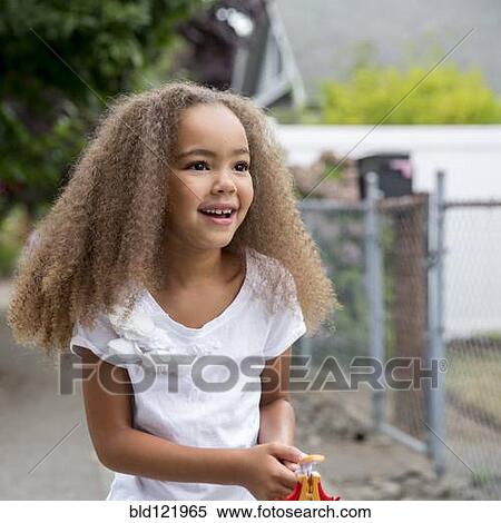 Mixed race girl walking outdoors View Large Photo Image Stock Photography - Mixed race girl walking outdoors. Fotosearch