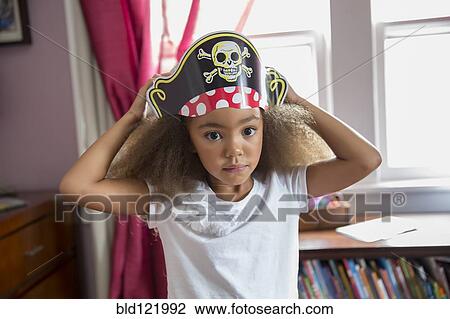 Mixed race girl wearing pirate hat in bedroom View Large Photo Image Stock Image - Mixed race girl wearing pirate hat in bedroom. Fotosearch