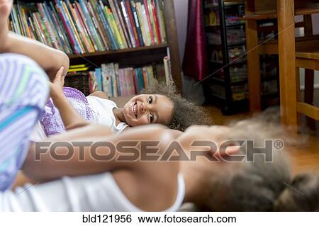 Mixed race girls playing in bedroom View Large Photo Image Stock Photograph - Mixed race girls playing in bedroom. Fotosearch