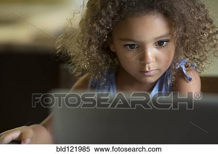 Mixed race girls using laptop View Large Photo Image Stock Photography - Mixed race girls using laptop. Fotosearch