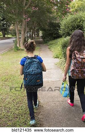 Mixed race girls walking to school View Large Photo Image Stock Photography - Mixed race girls walking to school. Fotosearch
