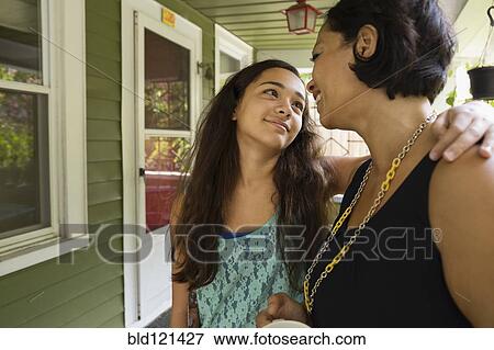 Stock Photo - Mixed race mother and daughter hugging. Fotosearch