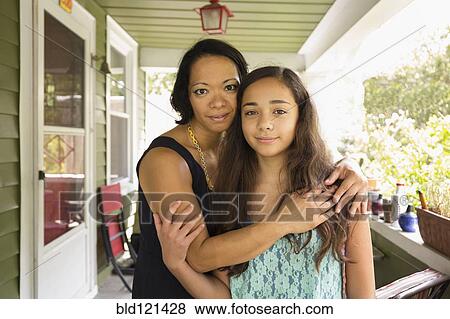 Mixed race mother and daughter hugging View Large Photo Image Stock Photo - Mixed race mother and daughter hugging. Fotosearch