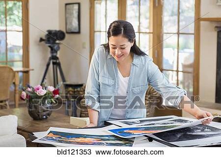 Mixed race photographer examining prints View Large Photo Image Stock Image - Mixed race photographer examining prints. Fotosearch