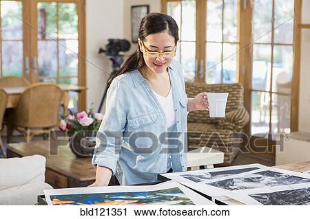 Mixed race photographer examining photographs View Large Photo Image Stock Image - Mixed race photographer examining photographs. Fotosearch