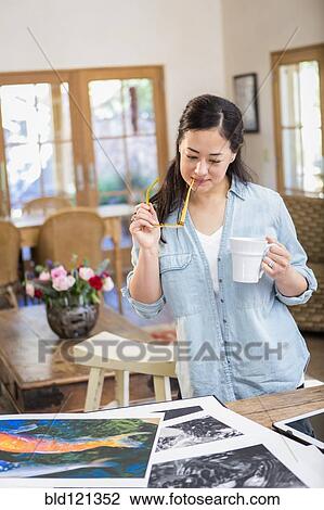 Mixed race photographer examining photographs View Large Photo Image Stock Image - Mixed race photographer examining photographs. Fotosearch