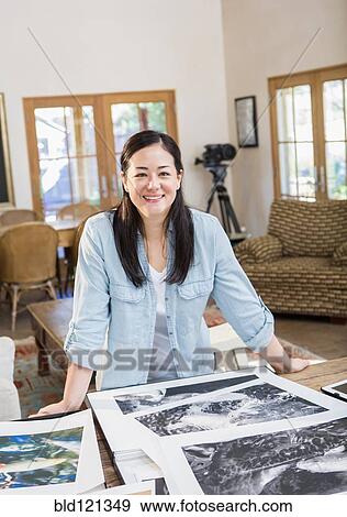 Mixed race photographer examining photographs View Large Photo Image Stock Photo - Mixed race photographer examining photographs. Fotosearch