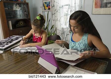 Mixed race sisters doing homework at table View Large Photo Image Stock Image - Mixed race sisters doing homework at table. Fotosearch