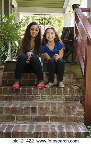 Mixed race sisters sitting on steps View Large Photo Image Stock Image - Mixed race sisters sitting on steps. Fotosearch