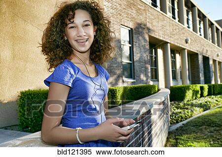 Mixed race student listening to headphones View Large Photo Image Stock Photography - Mixed race student listening to headphones. Fotosearch