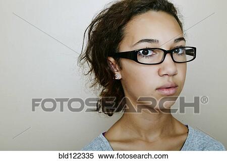 Stock Photography - Mixed race teenage girl wearing eyeglasses. Fotosearch