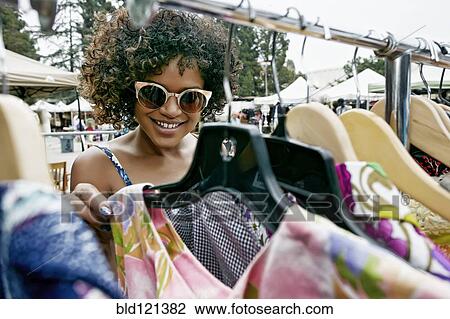 Mixed race woman shopping at flea market View Large Photo Image Stock Image - Mixed race woman shopping at flea market. Fotosearch