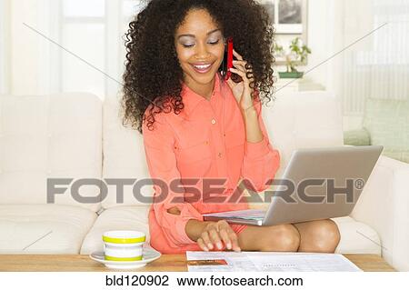 Mixed race woman shopping online View Large Photo Image Stock Image - Mixed race woman shopping online. Fotosearch
